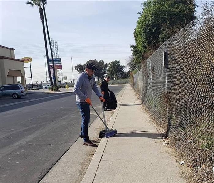 Here is Carlos Lopez and Benjamin Gutierrez cleaning up a dirty street in Bellflower